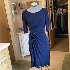Asymmetric drape knee length navy dress.